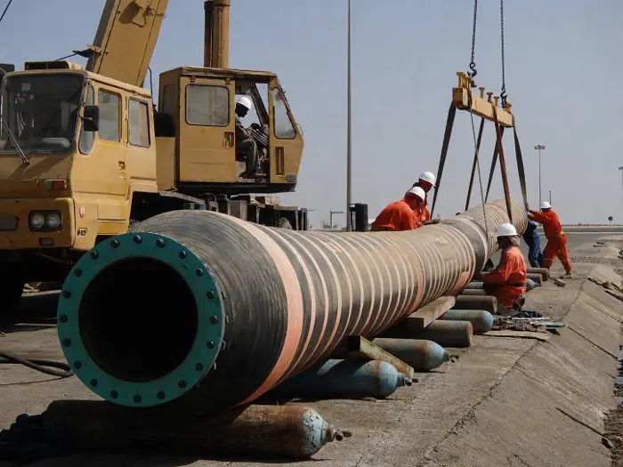 Marine hose being lifted by crane at a terminal